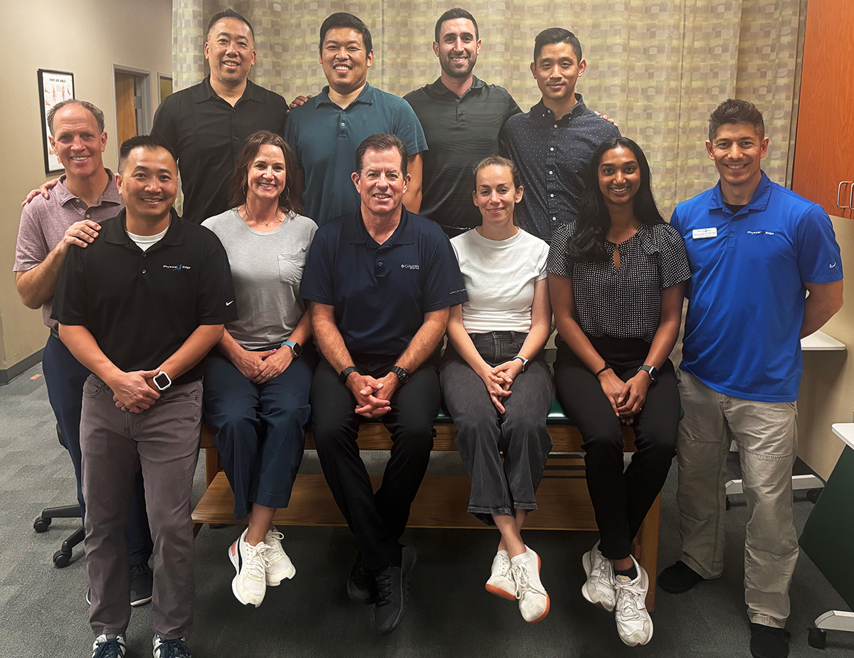Eleven people located in a physical therapy room