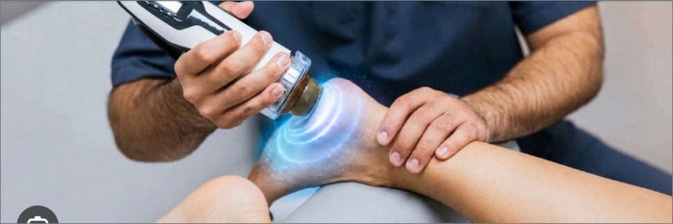 Medical professional applying shockwave therapy to the heel portion of the foot of a patient.